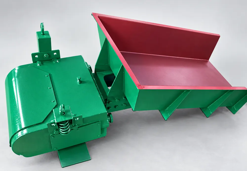 Green electromagnetic vibrating feeder with an enclosed drive housing and red inner feed tray